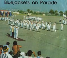 a group of people standing on top of a tarmac