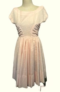 This is a sweet vintage dress from the 50s or early 60s. No labels. No size tags. The bust measures 34", waist 27", see measurements below.  Made of semi-sheer cotton or cotton blend in pale pink with a small white block in the fabric. It has a boat neck.  Waist is seamed & the skirt is very full all around. There are ruched panels.  The shoulders extend a little creating a cap style sleeve. Zips up the back with a long metal zipper. The dress is in good vintage condition. No soil or stains.  Side seams under the arms show reinforced repairs. Charming! Measurements were taken with the garment lying flat. If you have never worn vintage before, please measure yourself or a similar garment that fits you well & compare the measurements to these.  Vintage sizes run smaller than today's sizes, y Early 60s, Rose Pale, Cap Style, Metal Zipper, Side Panels, Pink Cotton, Vintage Dress, Dress Clothes For Women, Fit And Flare Dress