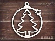 a metal christmas ornament with a tree inside on a wooden background, cut out from