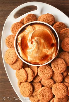 a white plate topped with cookies and dip