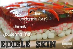 an edible cake with white marshmallows and red jelly on top that says edible skin