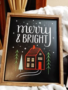 there is a sign that says merry and bright in front of a house with trees