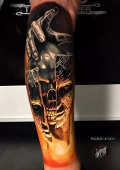 a man's leg with a tattoo on it and a skull in the middle