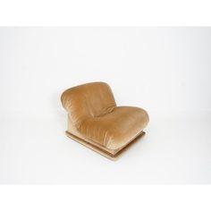 a brown chair sitting on top of a white floor