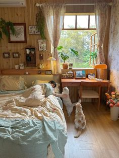 two dogs sitting on the floor in a bedroom