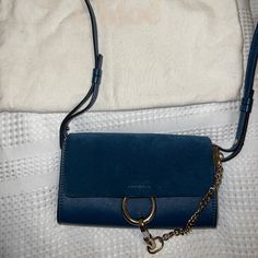 This Is An Authentic Chloe Suede Calfskin Small Wallet On A Strap Bag Purchased From Nordstrom.This Stylish Bag Is Crafted Of Fine Smooth Calfskin And Suede Leather In Blue. This Bag Features An Adjustable Leather Shoulder Strap, A Dark Suede Front Flap And Polished Silver And Gold Hardware Including A Decorative Ring Attached To A Clasp And Chain. The Flap Opens With A Button Snap To A Partitioned Beige Suede Interior. The Bag Has Been Used On A Few Times And Is In Excellent Condition From Both The Outside And Inside. It Comes With The Original Tag And Authenticity Cards. Chloe Faye Bag Blue, Majolica Blue, Strap Bag, Chloe Faye, Chloe Bag, Small Wallet, Stylish Bag, Silver And Gold, Bag Straps