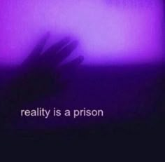 someone is holding their hand up in front of a purple background with the words reality is a prison