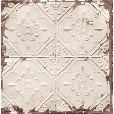 an old white tin ceiling tile with fleur de lis