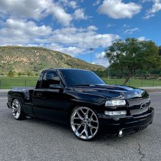 a black truck parked in a parking lot