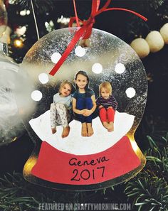 a snow globe ornament with two children in it