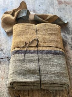 a folded brown and black cloth on top of a wooden table