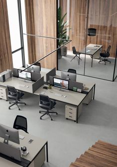 an office area with desks and chairs in front of a large glass window that reads france bureau