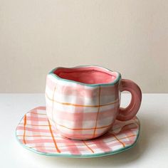 a cup and saucer sitting on top of a plate