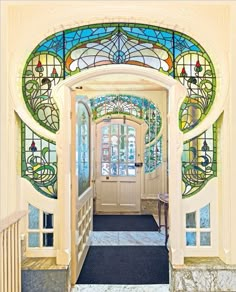 an entry way with stained glass doors and stairs