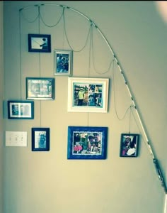 a wall with pictures hanging on it and a lamp in the corner next to it