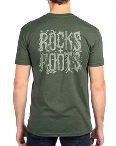 a man wearing a green t - shirt with the words rocks and roots printed on it