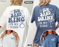 two women wearing matching shirts that say sun sand and drink on my hand, blue jean