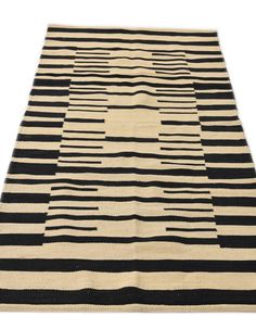 a black and white rug with wavy lines on the bottom, in different sizes and colors