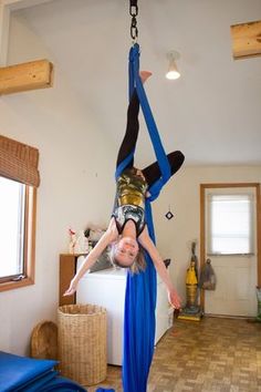 two people doing aerial acrobatics in a living room