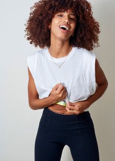 Light, airy and oh so cool. Our new pure women's white muscle tee is perfect for anything. Layer over your favorite jog bra and reveal a pop of color or tie in the back and create your own fitted crop top. This muscle workout shirt is shown in the softest lightweight white cotton. Model is wearing SIZE 1 White Muscle Tee, Muscle Workout, Fitted Crop Top, Muscle Tee, Muscle Fitness, Muscle Tees, Clothing Company, White Cotton, Workout Shirts