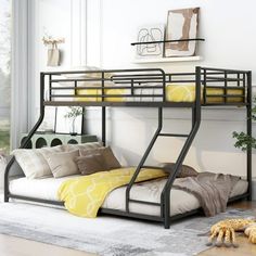 a black metal bunk bed with yellow pillows