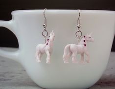 A pair of miniature and very detailed vinyl 3D white unicorns dangle from silvertone ear wires. Hypoallergenic Silver Kawaii Earrings, Flying Pig Earrings, Unicorn Earrings, Unicorn Jewelry, White Unicorn, Unicorn Pendant, Silver Tone, Favorite Jewelry, Jewelry Earrings Dangle