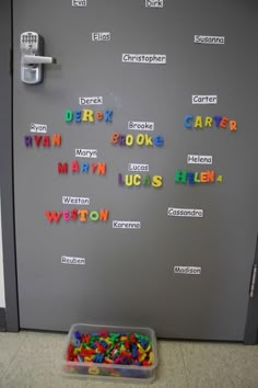 a refrigerator with magnets on the door and some words written in different colors next to it