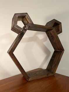 a wooden sculpture sitting on top of a wooden table