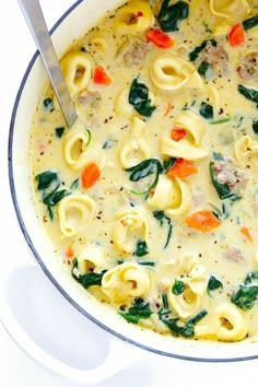 a pot filled with pasta and spinach soup