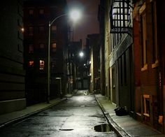 an empty city street at night with no one on it