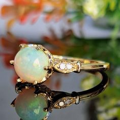 1.25 Carat Natural Opal & Diamonds 14k Solid Gold Ring Ring Material: 14k Solid Gold Total Metal Weight: 2.8 Grams Gemstone: Natural Opal Gemstone Color: Multicolor Gemstone Shape: Round Cabochon Gemstone Dimensions: 7.00x7.00 mm Gemstone Quantity: 1 Gemstone Carat Weight: 1.15 Carat Diamonds: Natural Round Shaped Diamonds Quantity: 4 Diamonds Total Carat Weight: 0.10 Carat Total Carat Weight: 1.25 Carat Ring Quantity: One Ring Condition: New Made in the USA Delivered in an elegant gift box Plea Solid Gold Ring, Yellow Gold Ring, One Ring, Natural Opal, Ring Ring, Birthstone Ring, Elegant Jewelry, Opal Gemstone, Diamond Clarity