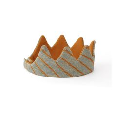 a crown made out of fabric with orange stripes on the top and bottom, sitting in front of a white background