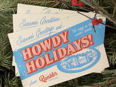 three holiday cards hanging from a tree with red berries on it's branches and the words hodgy holidays written in blue ink