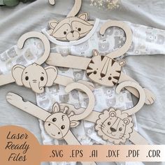 wooden cutouts of animals and giraffes on white fabric