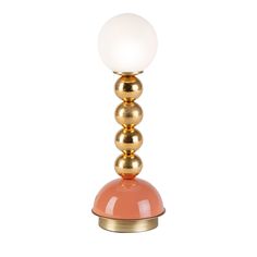 an orange and gold table lamp with a white ball on it's top, against a white background