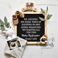 a baby announcement is displayed on a white table