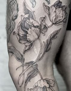 a close up of a person's thigh with flowers on it