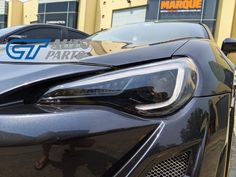 the front end of a black sports car