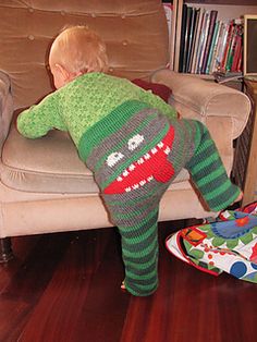 a toddler is playing on the couch