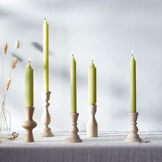 five candles are lined up on a table