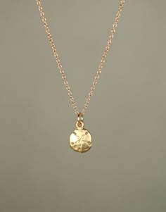 Gold sand dollar necklace - delicate necklace - a tiny 14k gold vermeil sand dollar hanging from a 14k gold filled chain A tiny 14k matte gold vermeil sand dollar hangs from a 14k gold filled chain in the length of your choice.  Please feel free to select a different length if you prefer!  I can also make a set of matching dangling earrings if you like.  Now available in sterling silver!  This tiny sand dollar measures 8mm. Looking for an ever so slightly bigger sand dollar? https://www.etsy.com Sand Dollar Earrings, Sand Dollar Necklace, Button Piercing, Beachy Jewelry, Preppy Jewelry, Gold Sand, Jewelry Accessories Ideas, Gold Overlay, Jewelry Essentials