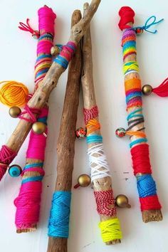 several different types of yarn wrapped in wood sticks