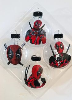 four ornament shaped like deadpool ornaments