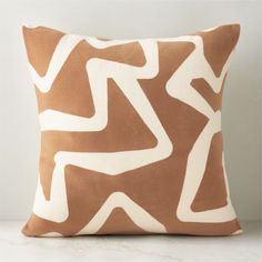 a brown and white pillow sitting on top of a table