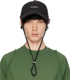 Cotton twill cap in black. · Embroidered eyelet vents at crown · Logo hardware at face · Frayed edge at curved brim · Cord-lock chin strap · Cinch strap at back face · Logo-engraved silver-tone hardware Part of the Le Chouchou collection. Supplier color: Black Jacquemus Hat, Tiktok Content, Cap Outfit, Denim Cap, Crown Logo, Face Logo, Black Accessories, Silver Engraving, Cotton Twill