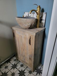 a bathroom sink sitting on top of a wooden cabinet