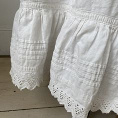 This gorgeous textile is French and dates from the late 1800's or very early 1900's . White, crisp cotton with lace detail. I love wearing these with boots! ~ GORGEOUS! Ideal for wearing, display or design inspiration ( E 127 ) MEASUREMENTS : This gorgeous Vintage French skirt measures : 33 inches long 28 inch approx. CONDITION : I've freshly laundered and pressed this gorgeous textile. There are rust stains on the clasp area ( please see photographs) and the body has some tiny tiny rust stains White Broderie Anglaise Cotton Skirt, White Cotton Skirt With Broderie Anglaise, Vintage White Gathered Skirt Bottoms, Vintage White Lace Bottoms, White Vintage Lace Bottoms, White Lace Vintage Bottoms, Cotton Skirt With Lace Trim For Daywear, Vintage Cotton Tiered Petticoat, Victorian White Ruffled Petticoat