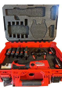 an orange tool box filled with tools on top of a white surface