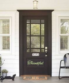 a black front door on a white house