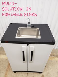 a white sink sitting next to a black counter top under a sign that says multi - solution in portable sinks